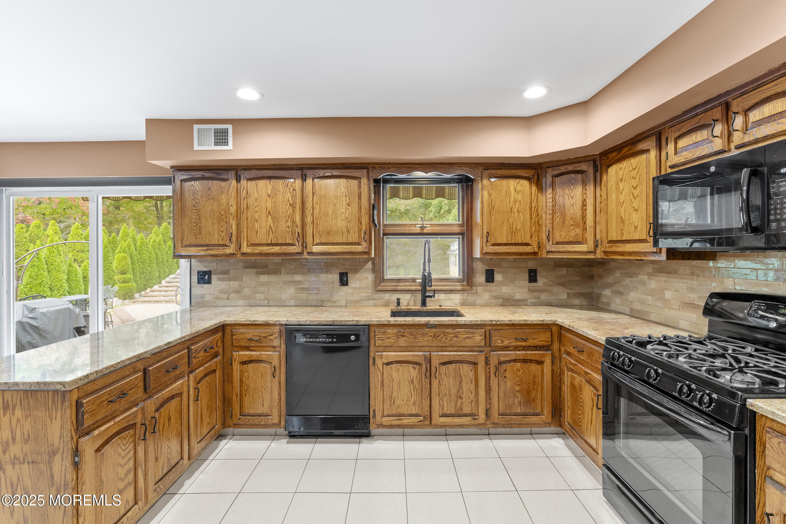 16 Timber Lane Manalapan, NJ 07726 - Photo 13 of 54 a kitchen with a sink stove top oven and cabinets