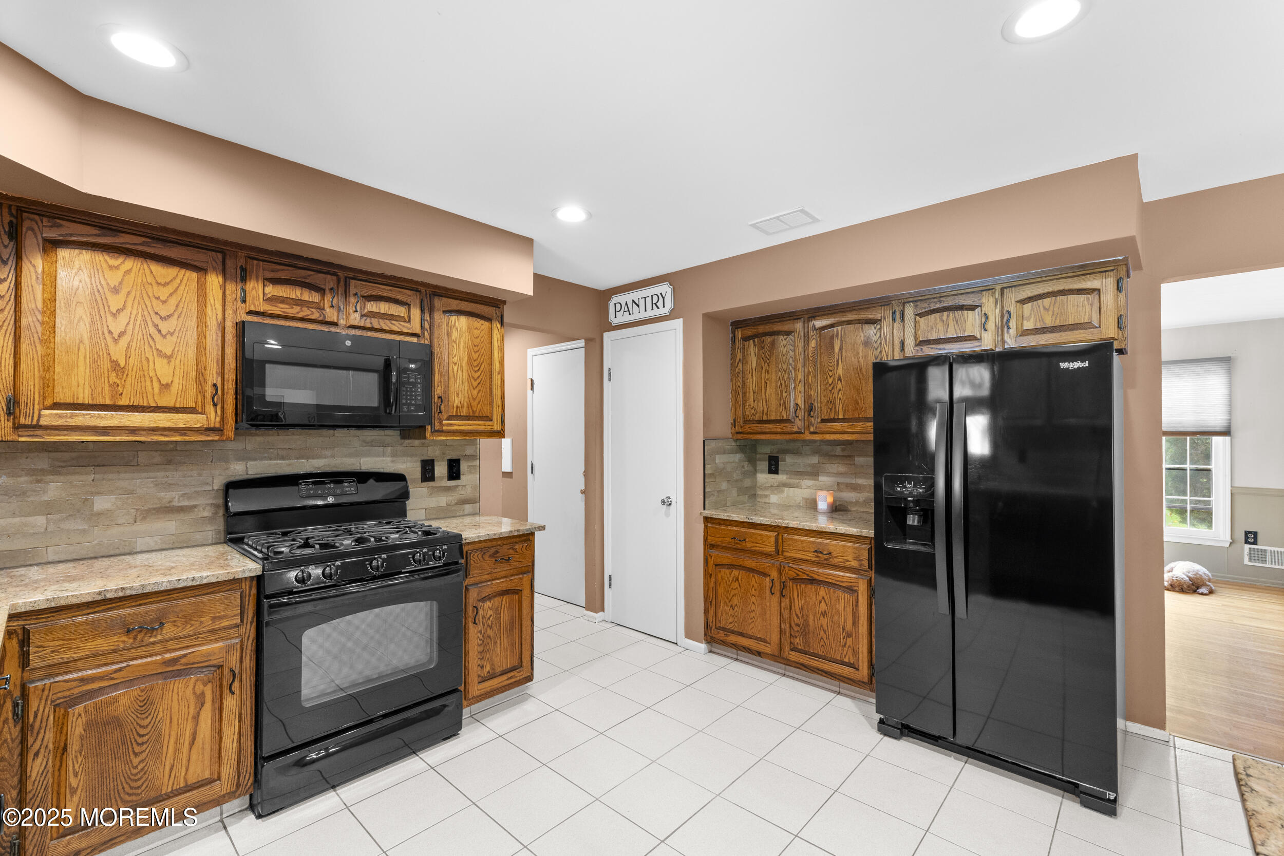 16 Timber Lane Manalapan, NJ 07726 - Photo 14 of 54 a kitchen with granite countertop a refrigerator and a stove top oven