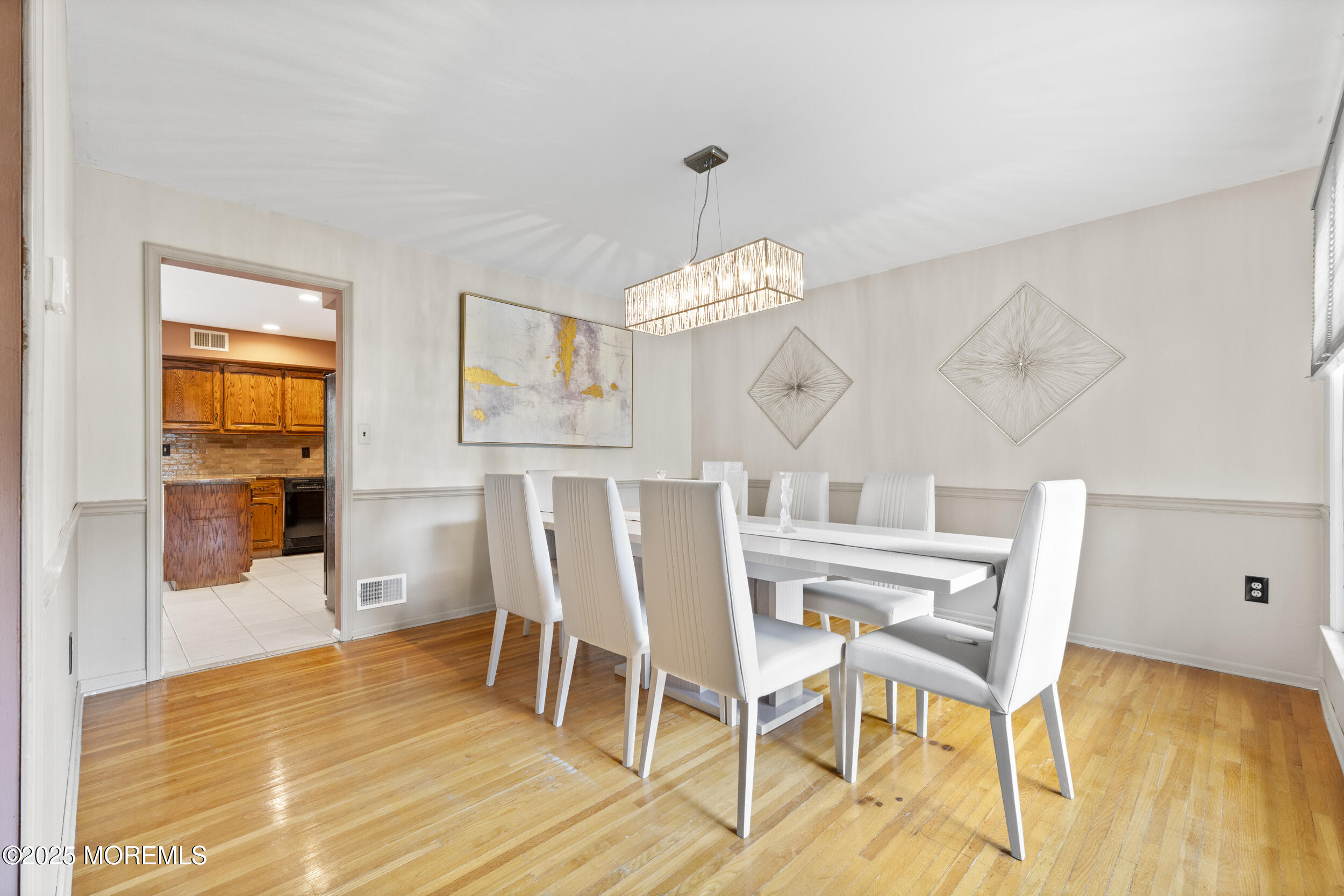 16 Timber Lane Manalapan, NJ 07726 - Photo 16 of 54 a view of a dining room with furniture and wooden floor