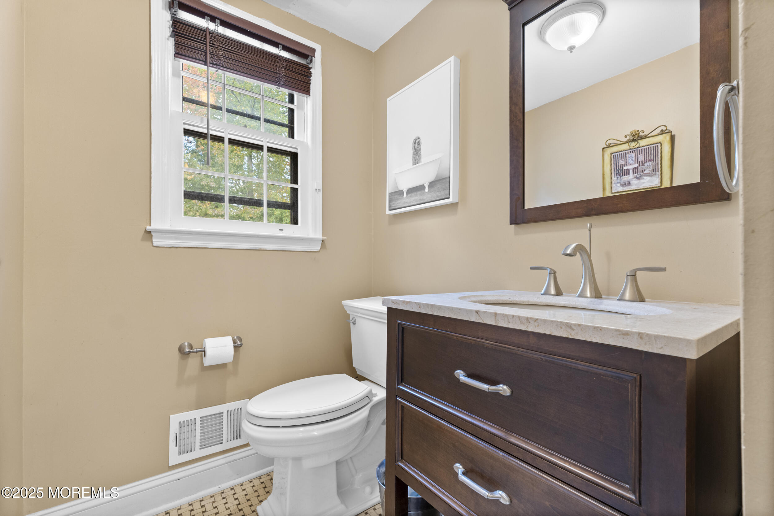 16 Timber Lane Manalapan, NJ 07726 - Photo 18 of 54 a bathroom with a toilet a sink a vanity and mirror