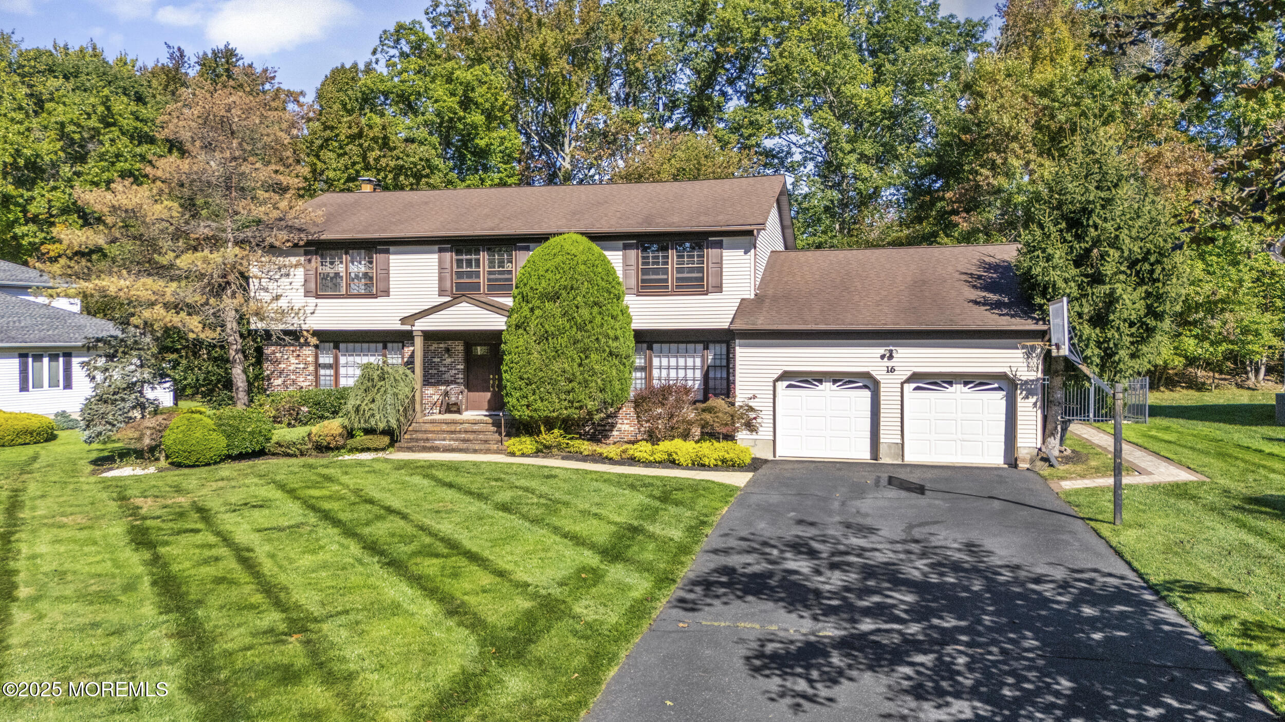 16 Timber Lane Manalapan, NJ 07726 - Photo 2 of 54 a front view of a house with a yard table and chairs
