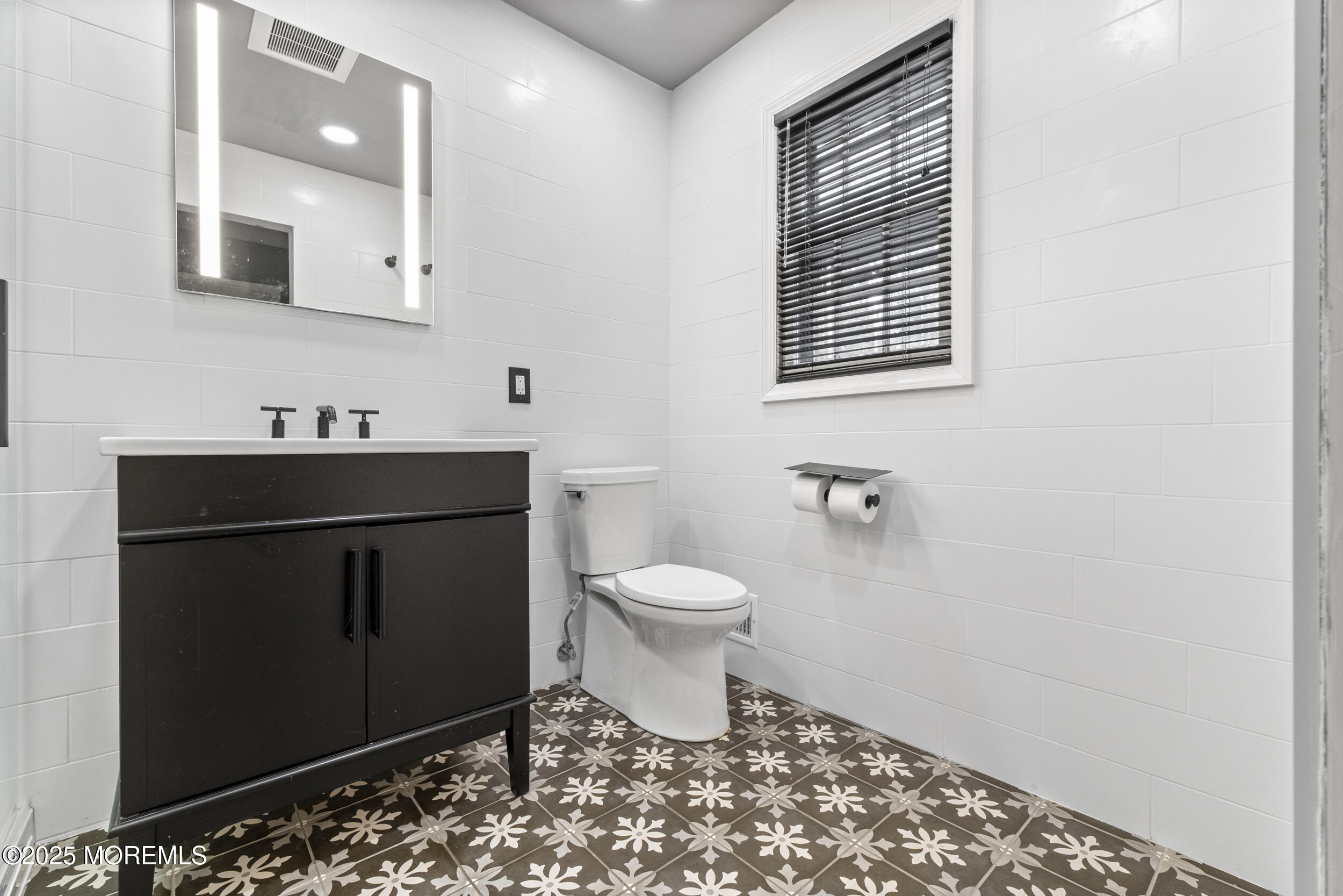 16 Timber Lane Manalapan, NJ 07726 - Photo 24 of 54 a bathroom with a sink toilet and vanity