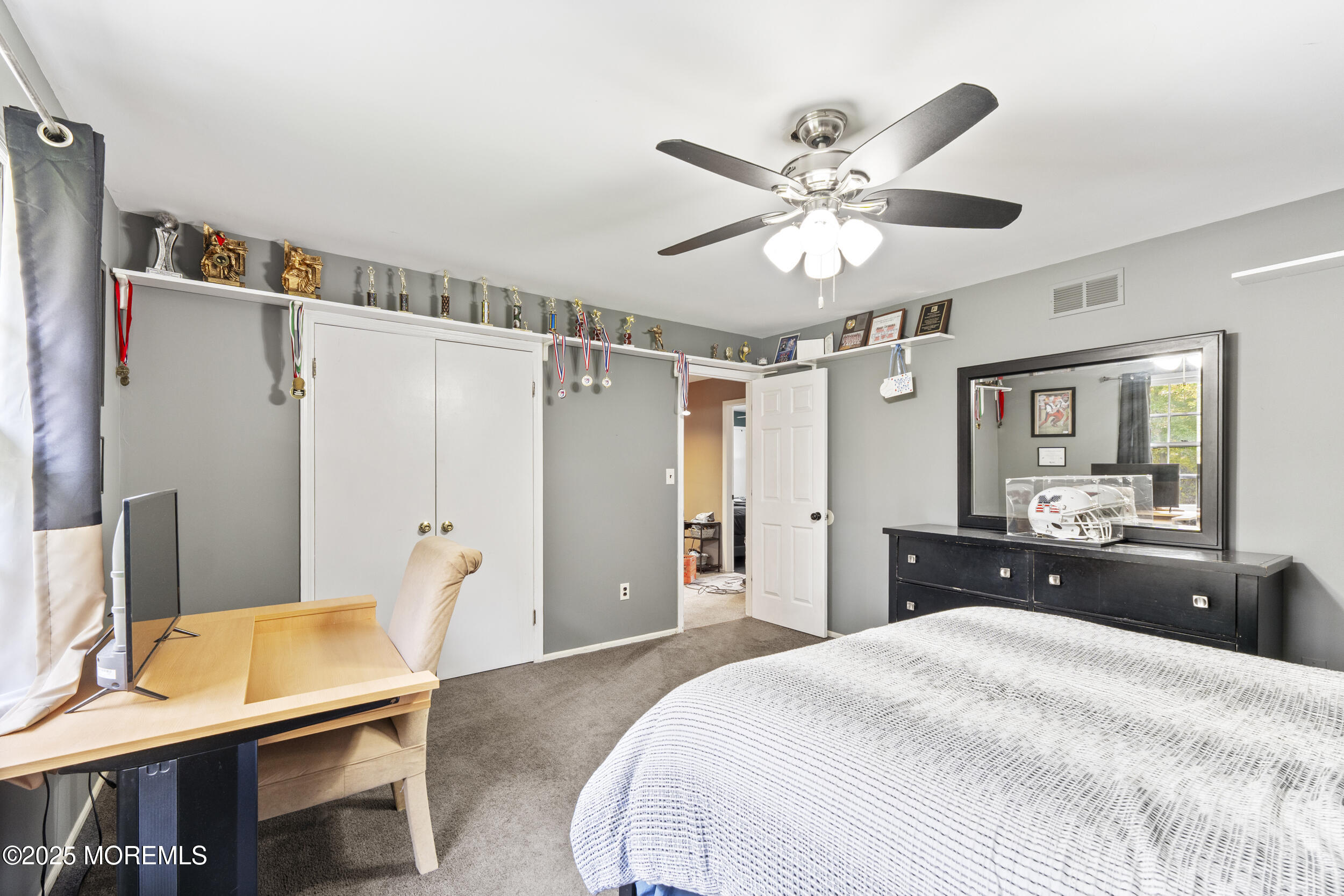 16 Timber Lane Manalapan, NJ 07726 - Photo 27 of 54 a bedroom with a bed and a chandelier