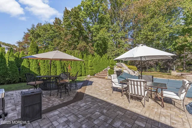 a view of a patio with couches chairs and a potted plant