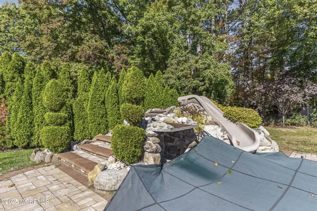 an aerial view of a house with garden space and street view