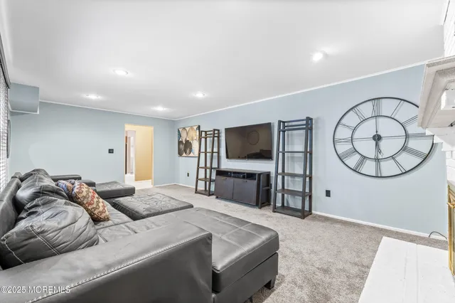a large kitchen with a large window and stainless steel appliances