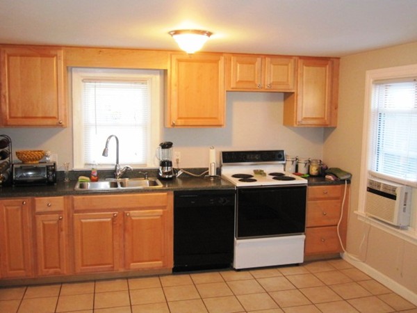 322 Abbott Street Springfield, MA 01118 - Photo 5 of 11 a kitchen with stainless steel appliances granite countertop a stove a sink and a refrigerator
