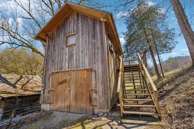 a view of a house with a yard covered with snow in front of house