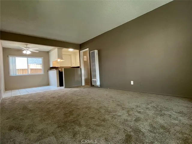 a kitchen with stainless steel appliances a stove a sink and white cabinets