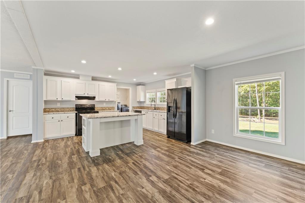 89 Ridge Road Seale, AL 36875 - Photo 14 of 46 Kitchen and living area featuring wood-finish flooring, white cabinetry, granite countertops, a central island, and recessed lighting