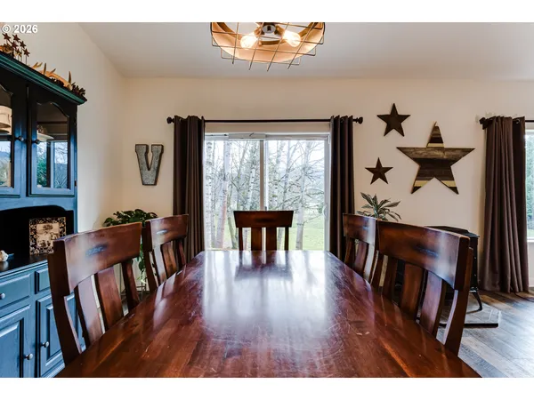 a dining room with furniture and wooden floor