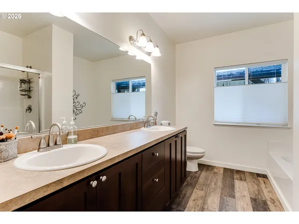 a bathroom with a sink double vanity granite and a mirror
