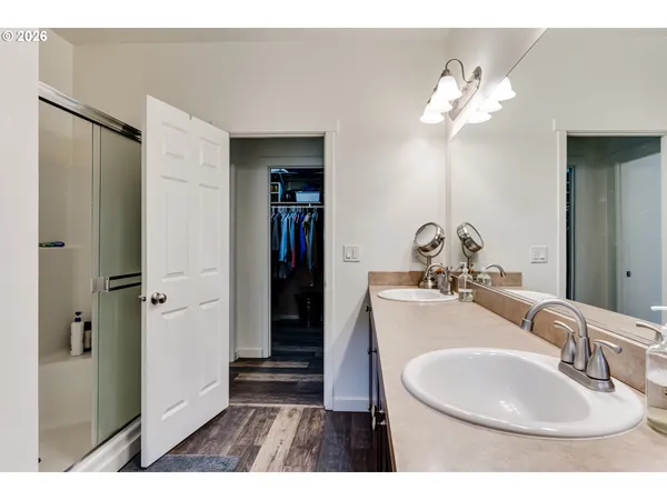 a bathroom with a sink a mirror and shower