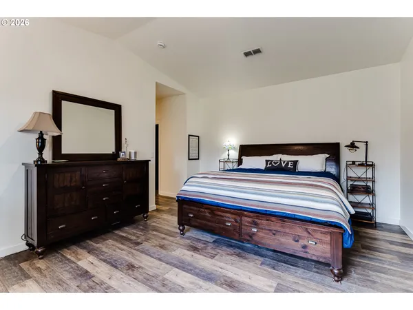 a bedroom with a bed and a dresser