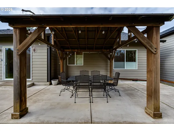a view of a patio with table and chairs with wooden floor