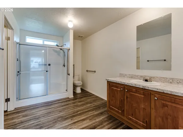 a view of a field of grass and trees