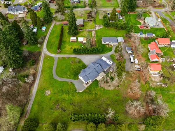 an aerial view of a house with a yard basket ball court and outdoor seating