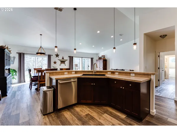 a kitchen with a sink cabinets and wooden floor