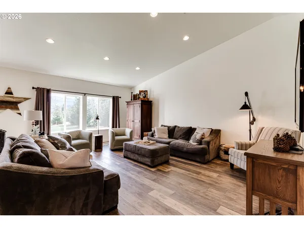 a living room with furniture a couch and a flat screen tv