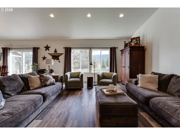 a living room with furniture and wooden floor
