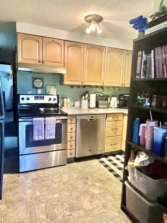 15 Old County Road Holland, MA 01521 - Photo 15 of 22 a kitchen with stainless steel appliances granite countertop a stove a sink and a refrigerator