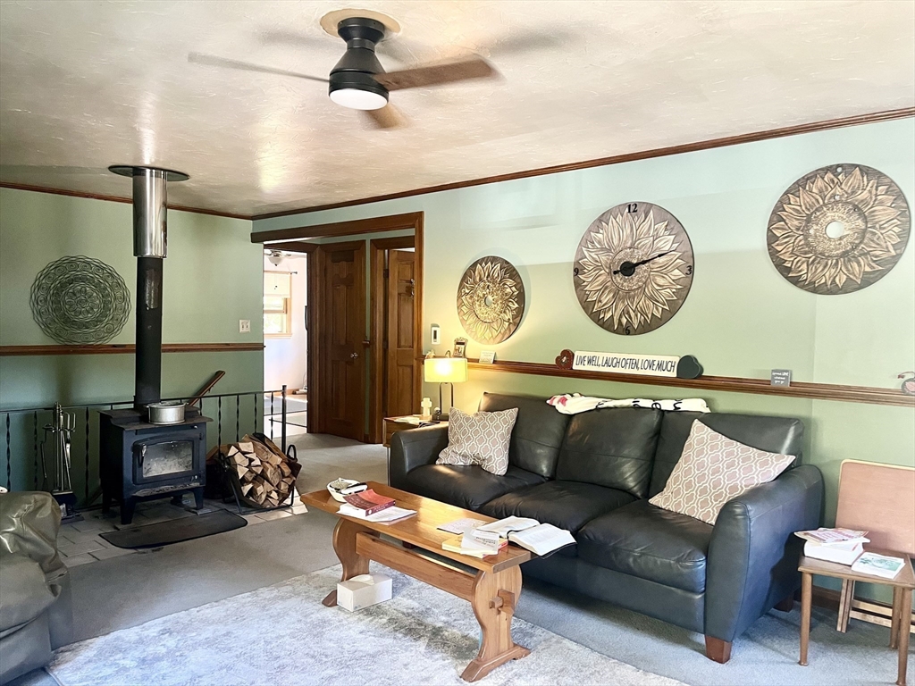 15 Old County Road Holland, MA 01521 - Photo 2 of 22 a living room with furniture a rug and a wall painting