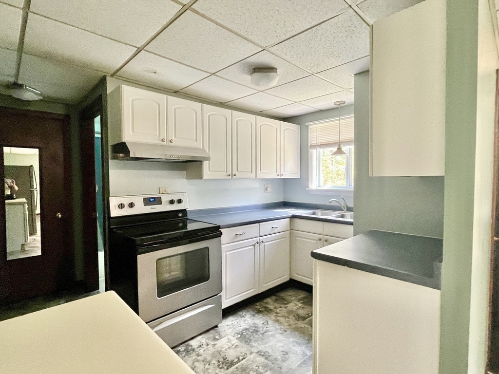 15 Old County Road Holland, MA 01521 - Photo 7 of 22 a kitchen with stainless steel appliances granite countertop a stove a sink and a refrigerator