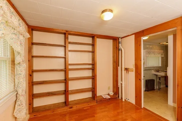 a view of a room with wooden floor and windows