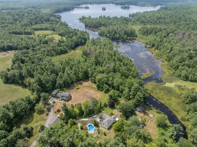 an aerial view of a house with a yard