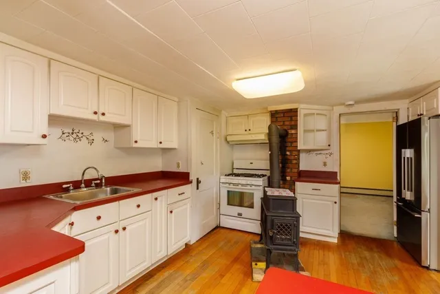 a kitchen with white cabinets and stainless steel appliances