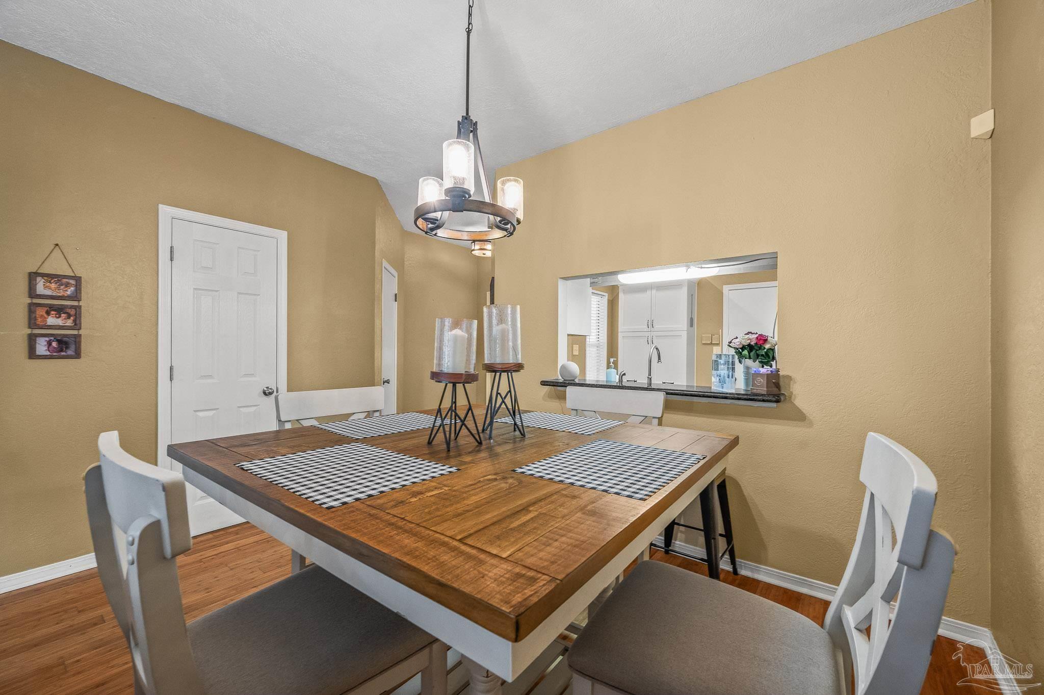 601 East Burgess Road, Unit K1 Pensacola, FL 32504 - Photo 11 of 41 a view of a dining room with furniture and wooden floor
