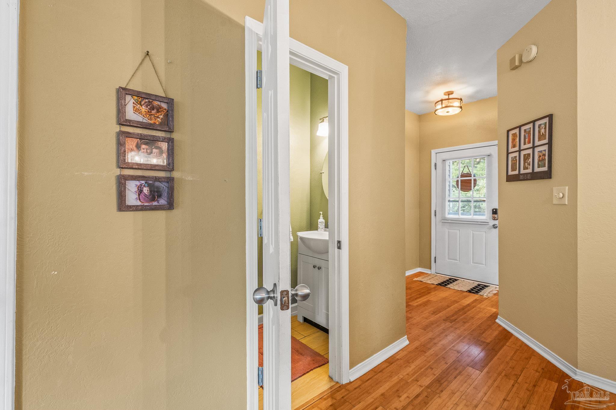 601 East Burgess Road, Unit K1 Pensacola, FL 32504 - Photo 13 of 41 a view of a hallway with wooden floor and closet