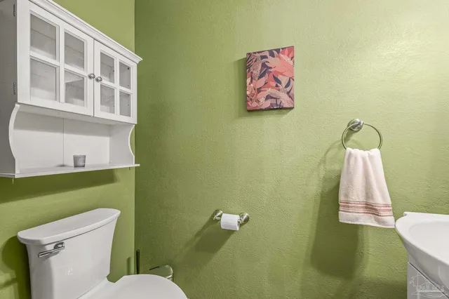 a bathroom with a toilet and a sink