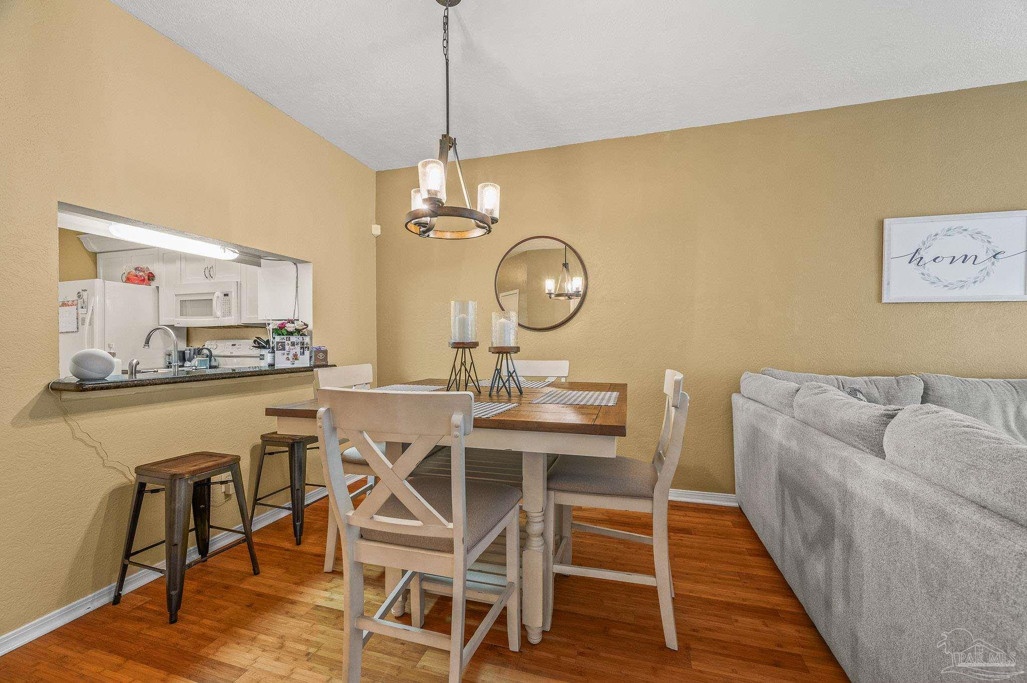 601 East Burgess Road, Unit K1 Pensacola, FL 32504 - Photo 16 of 41 a view of a dining room with furniture and wooden floor