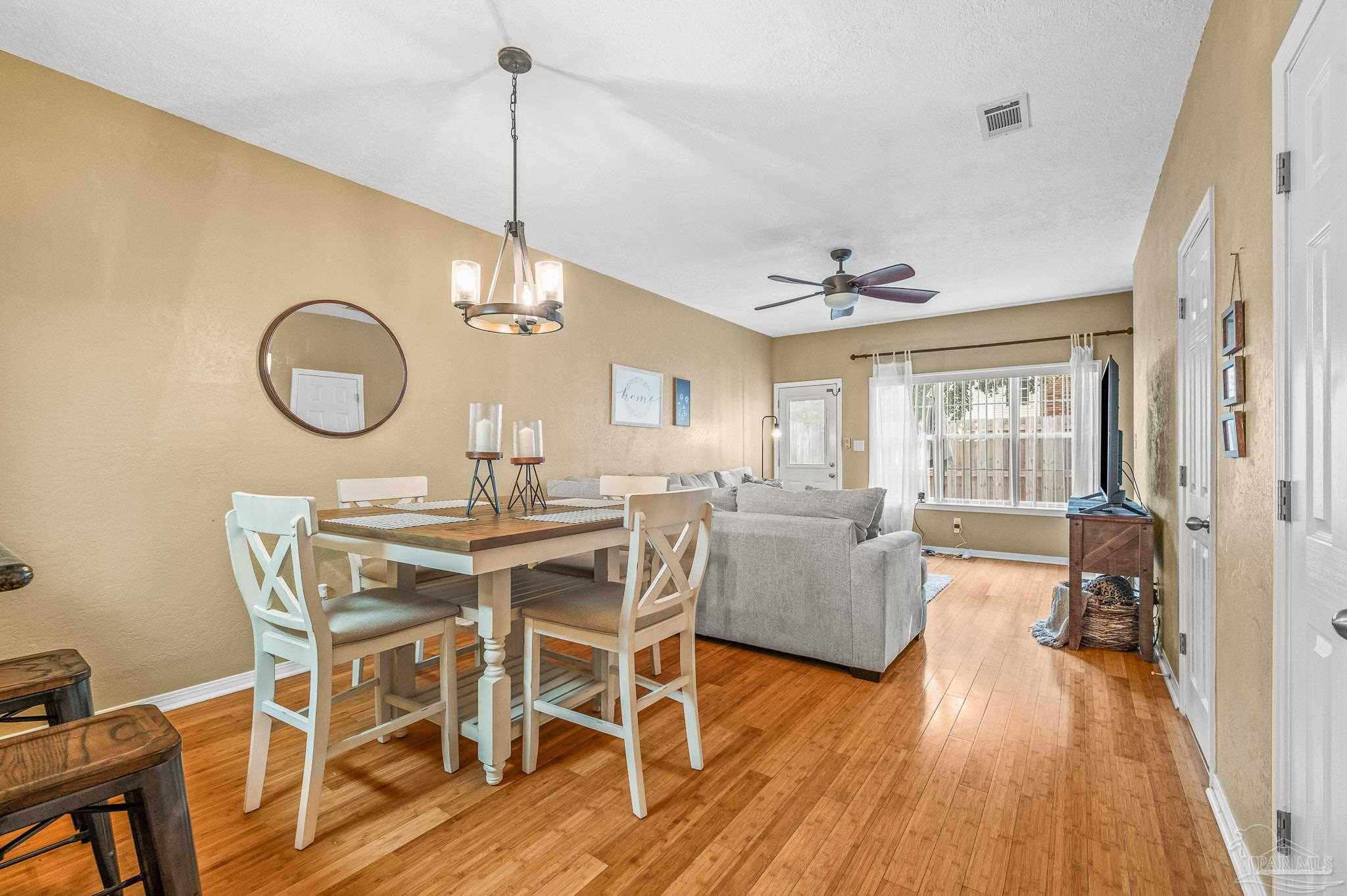 601 East Burgess Road, Unit K1 Pensacola, FL 32504 - Photo 17 of 41 a view of a dining room with furniture window and wooden floor