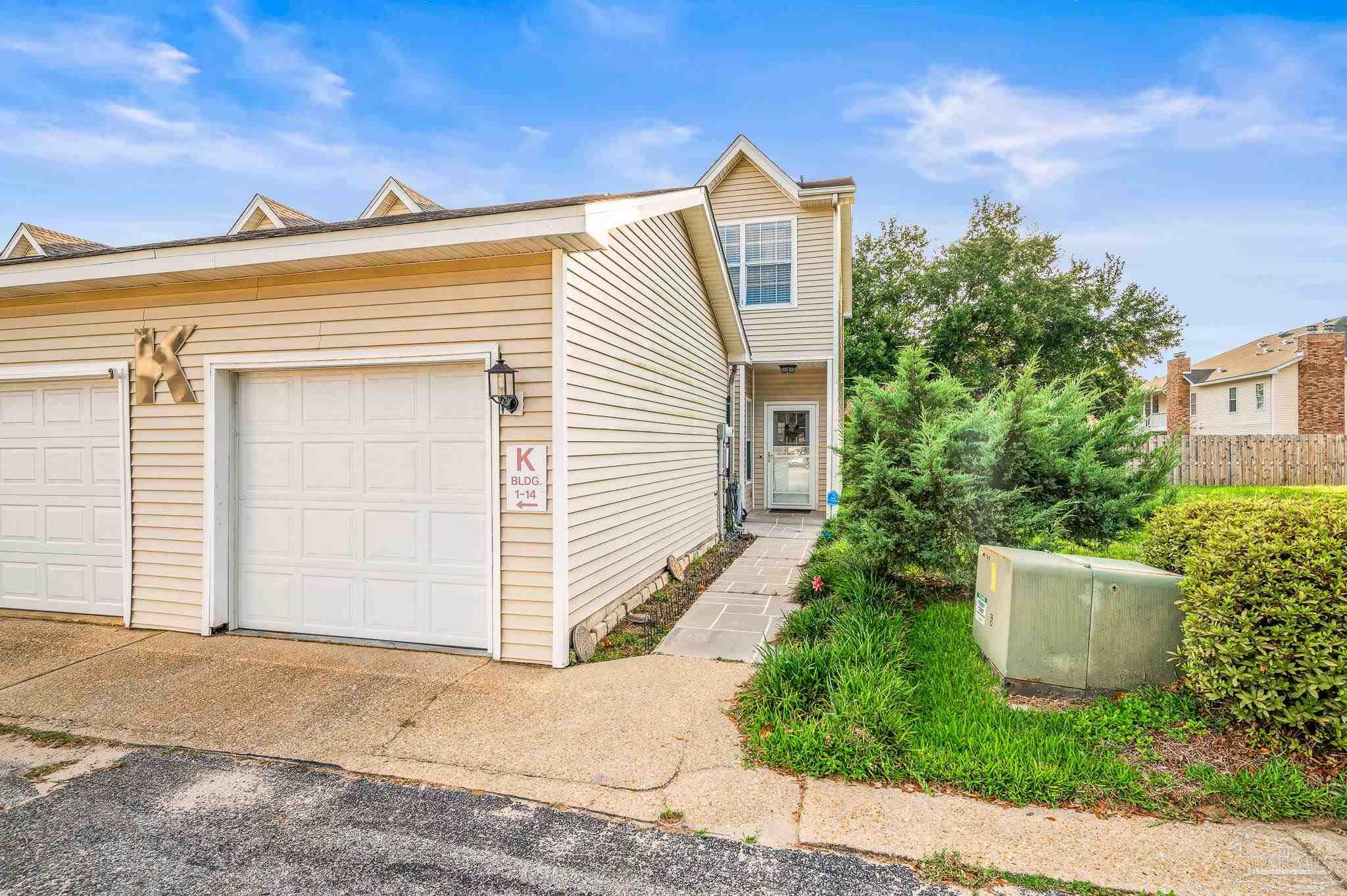 601 East Burgess Road, Unit K1 Pensacola, FL 32504 - Photo 2 of 41 a view of a house with a yard