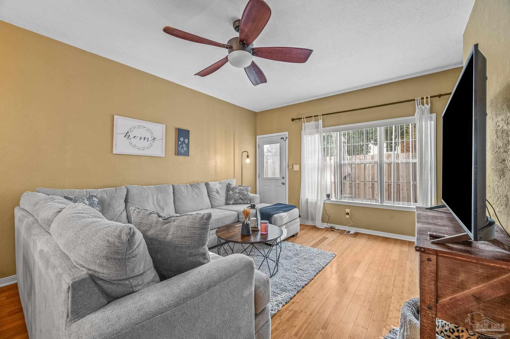 601 East Burgess Road, Unit K1 Pensacola, FL 32504 - Photo 21 of 41 a living room with furniture and a flat screen tv