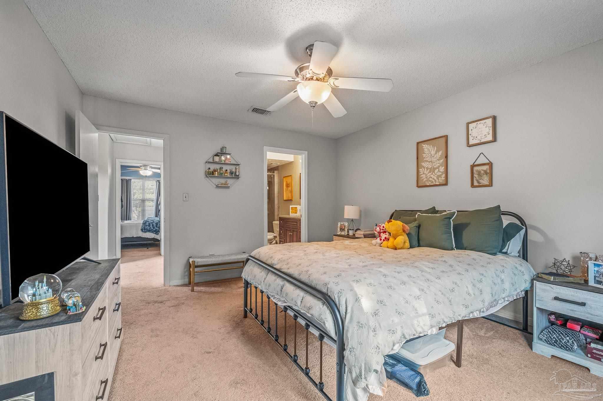 601 East Burgess Road, Unit K1 Pensacola, FL 32504 - Photo 25 of 41 a bedroom with a bed and a flat screen tv