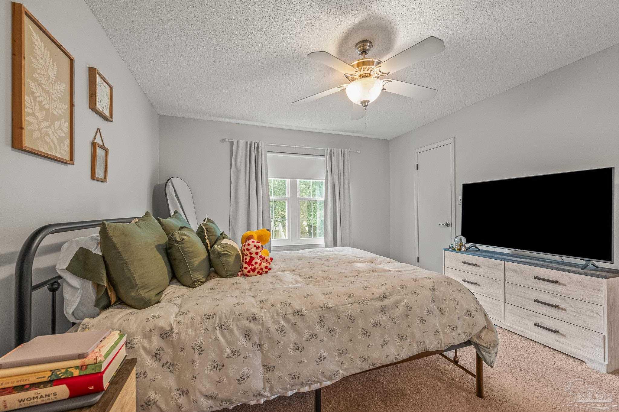 601 East Burgess Road, Unit K1 Pensacola, FL 32504 - Photo 27 of 41 a bedroom with a bed and a flat screen tv