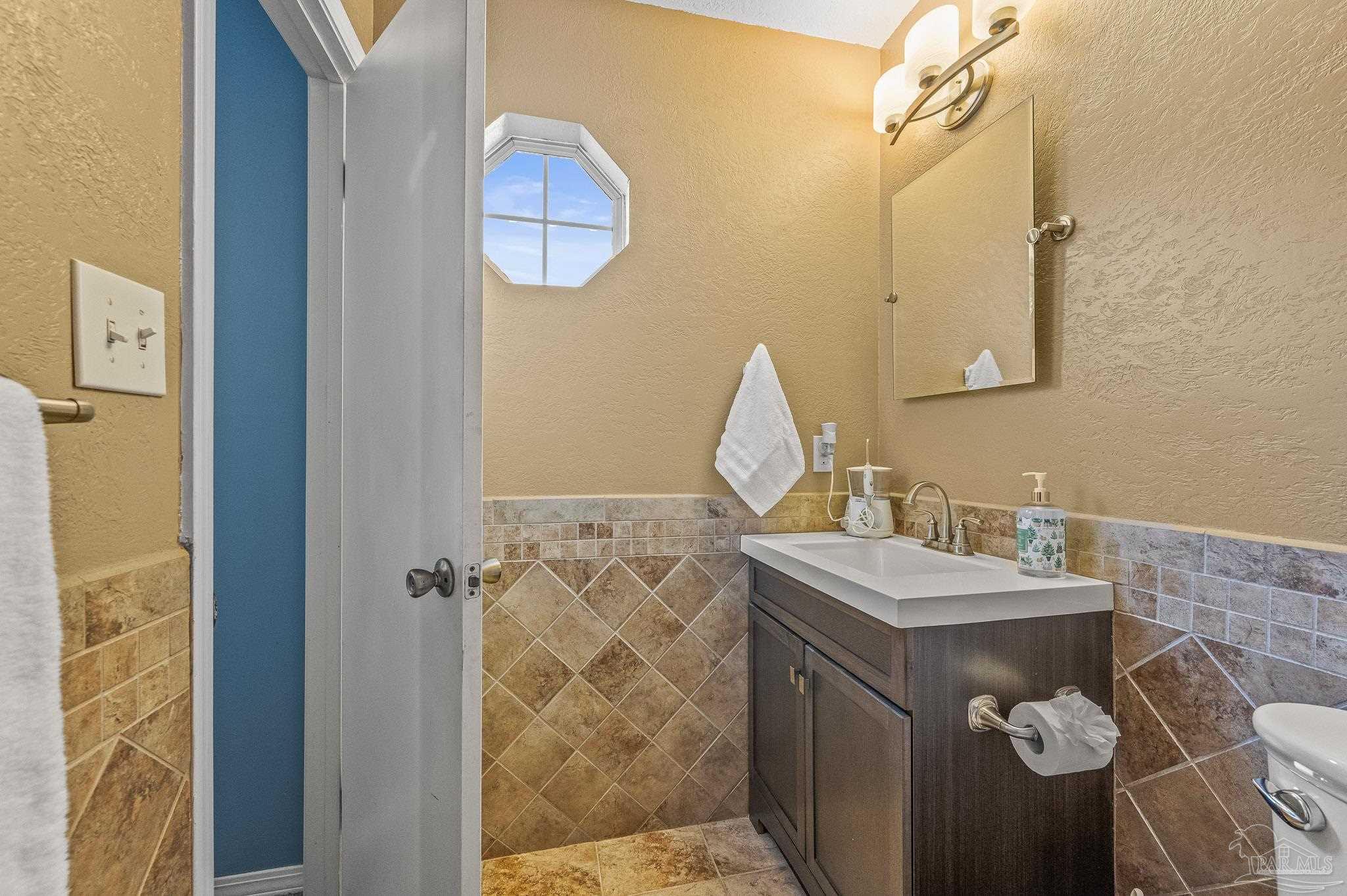 601 East Burgess Road, Unit K1 Pensacola, FL 32504 - Photo 32 of 41 a bathroom with a sink vanity and a mirror
