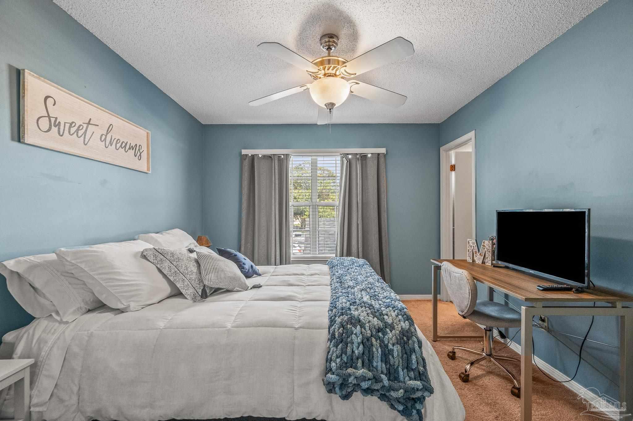 601 East Burgess Road, Unit K1 Pensacola, FL 32504 - Photo 33 of 41 a bedroom with a bed and a flat screen tv