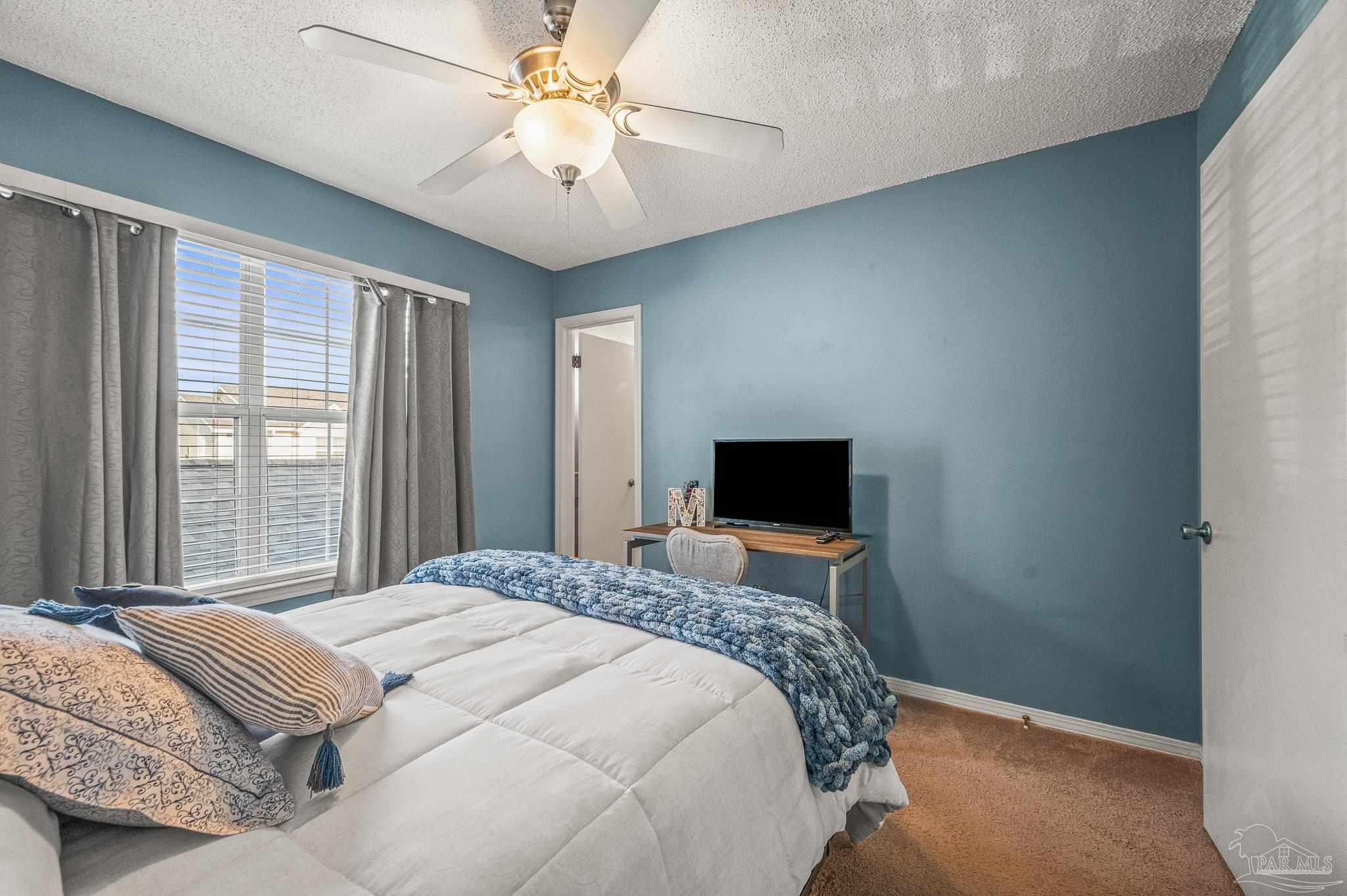 601 East Burgess Road, Unit K1 Pensacola, FL 32504 - Photo 34 of 41 a bedroom with a bed and a chandelier