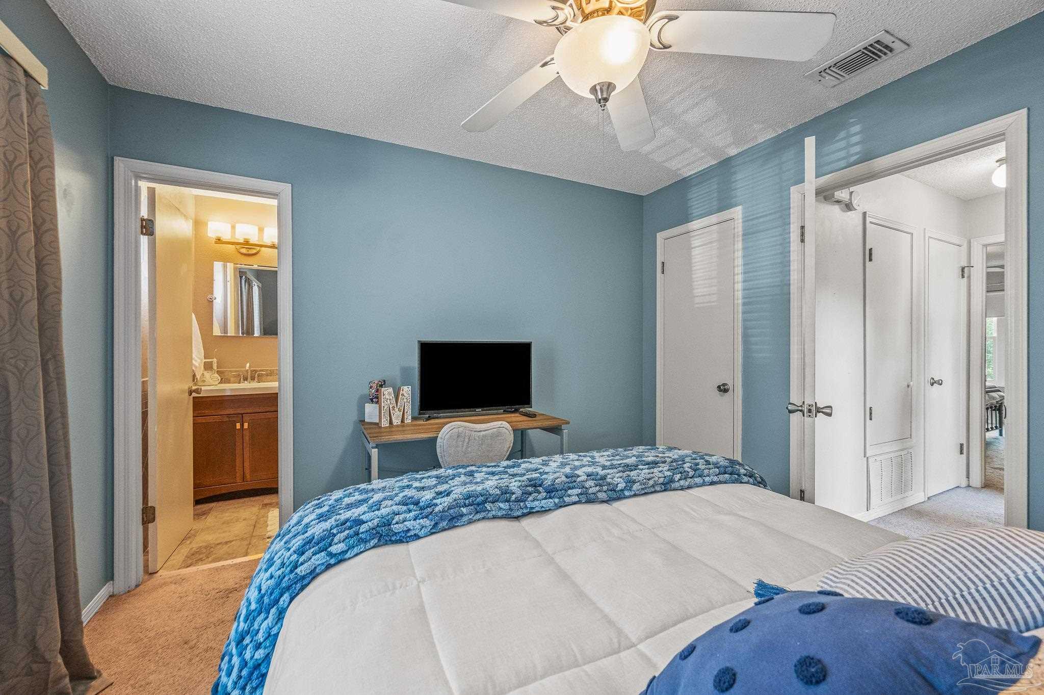 601 East Burgess Road, Unit K1 Pensacola, FL 32504 - Photo 36 of 41 a bedroom with a bed and a chandelier