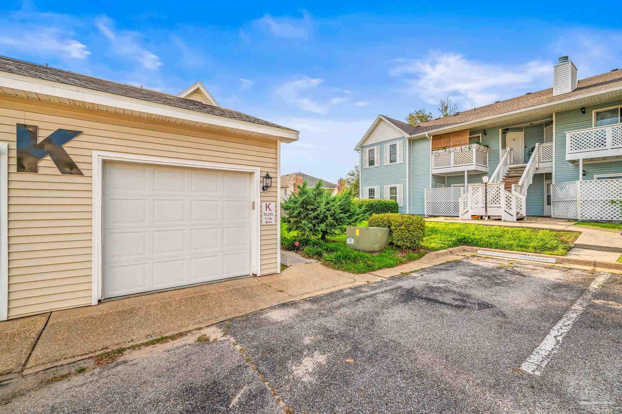 601 East Burgess Road, Unit K1 Pensacola, FL 32504 - Photo 4 of 41 a front view of a house with a yard and a garage
