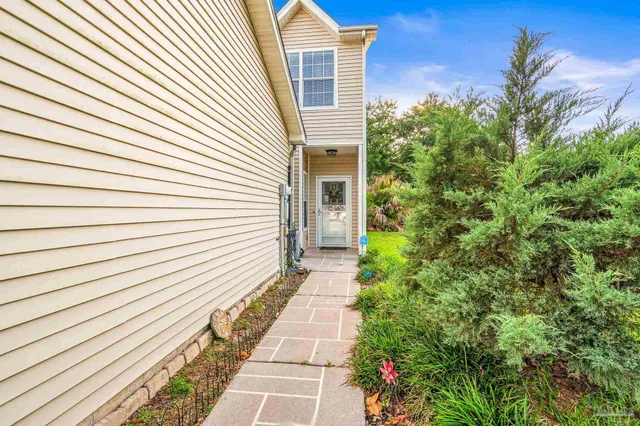 a view of a pathway with a house in the background