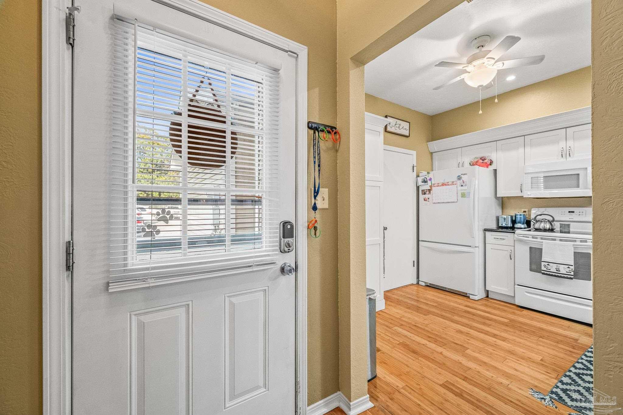 601 East Burgess Road, Unit K1 Pensacola, FL 32504 - Photo 5 of 41 a kitchen with stainless steel appliances white cabinets and a refrigerator