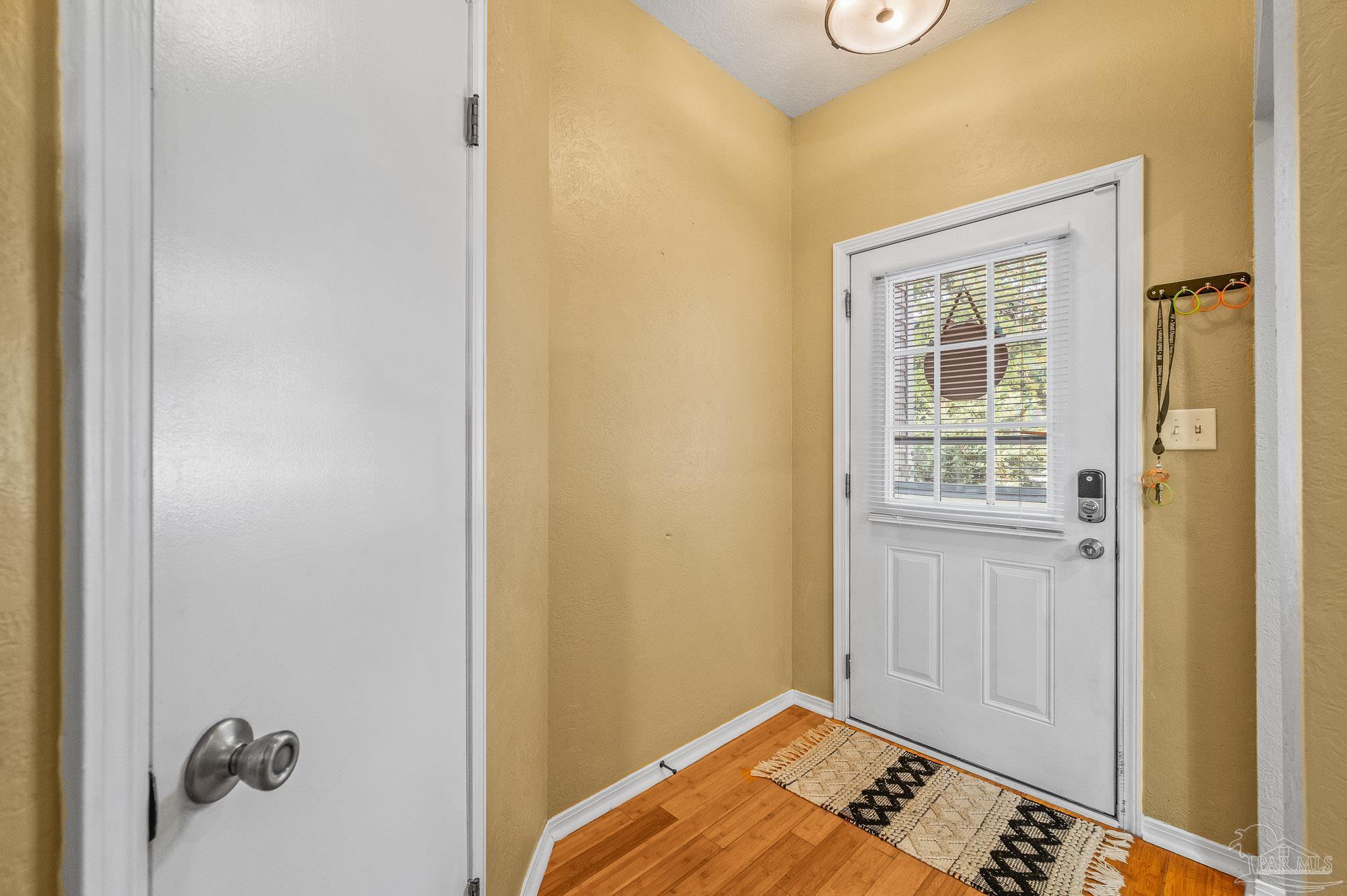 601 East Burgess Road, Unit K1 Pensacola, FL 32504 - Photo 6 of 41 a view of a bedroom with wooden floor and closet