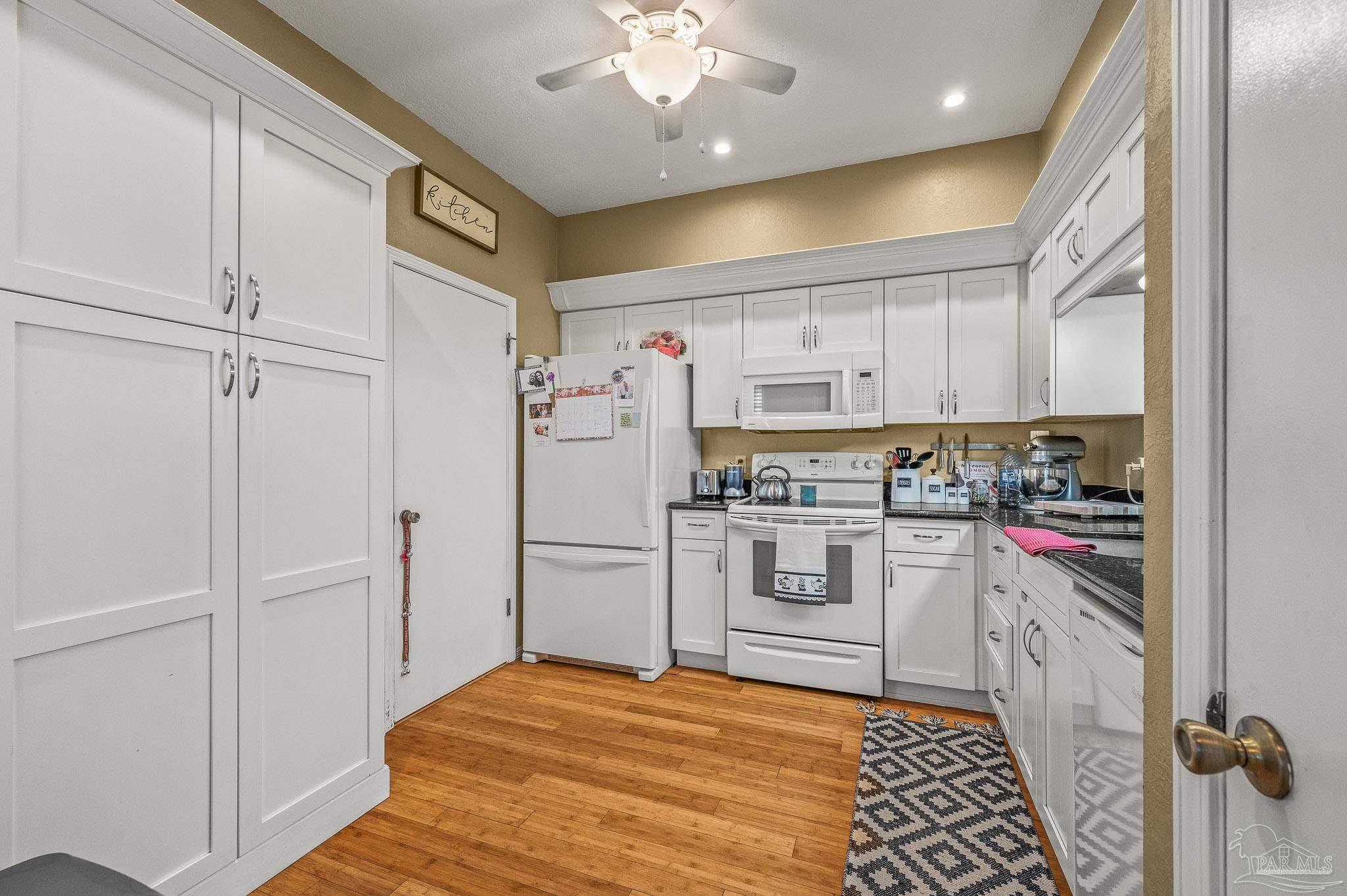 601 East Burgess Road, Unit K1 Pensacola, FL 32504 - Photo 8 of 41 a kitchen with white cabinets and stainless steel appliances