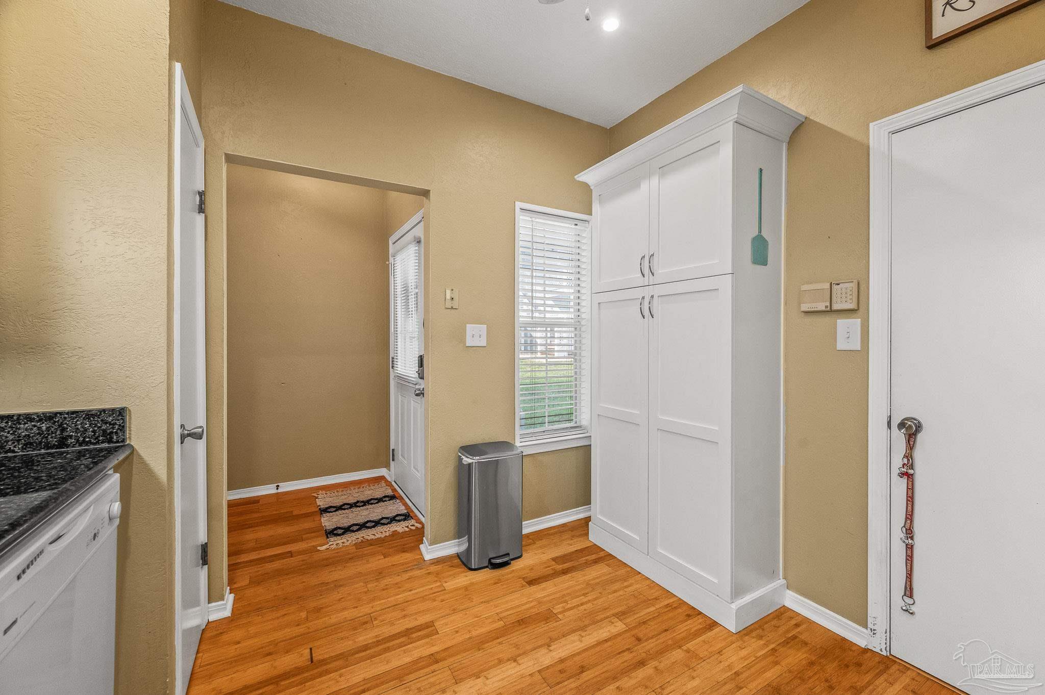 601 East Burgess Road, Unit K1 Pensacola, FL 32504 - Photo 10 of 41 a view of a kitchen with wooden floor and a sink