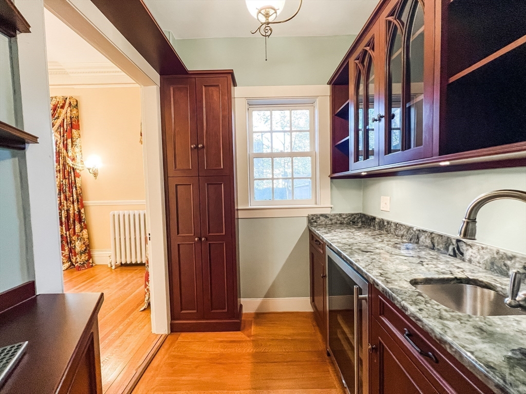 62 Old River Place Dedham, MA 02026 - Photo 13 of 39 a kitchen with granite countertop a sink dishwasher stove and cabinets